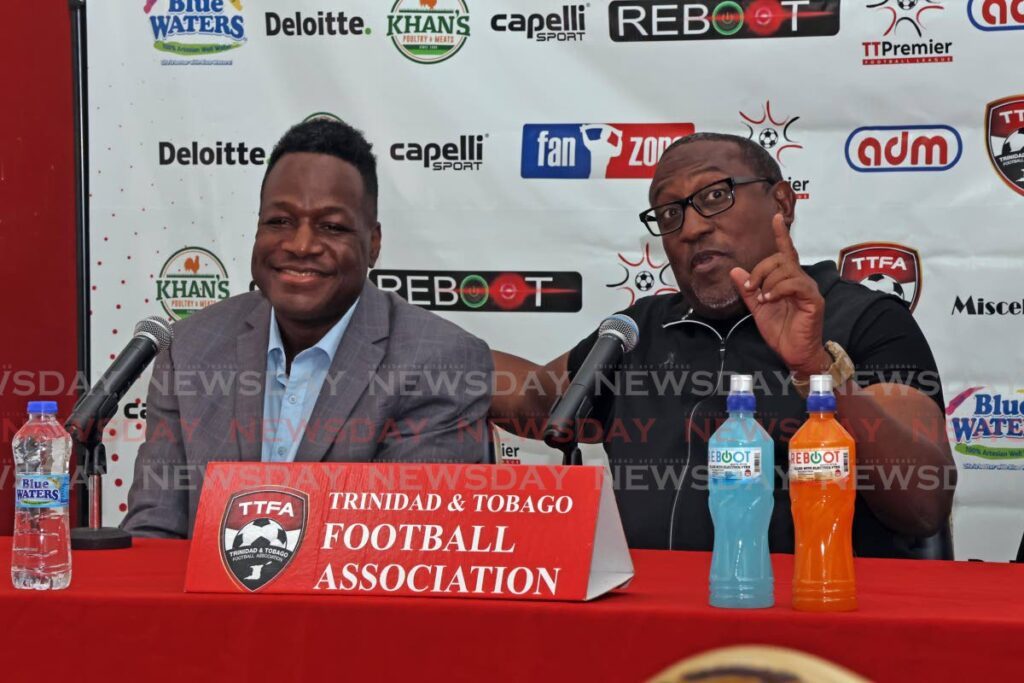 Caledonia AIA technical director Jamaal Shabazz (R) speaks during a TT Premier Football League press conference, on December 5, at the Ato Boldon Stadium, Couva. At left, Rangers FC head coach Dave Quamina looks on.  - Lincoln Holder