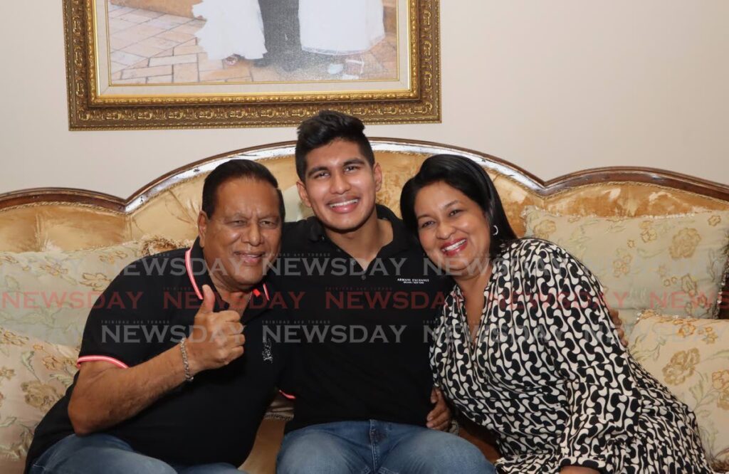 CAPE President's winner Teddy Mohammed Jnr, centre, with his parents Teddy Mohammed and Deanne Mohammed at their home in Valsayn on December 5. - Photo by Ayanna Kinsale