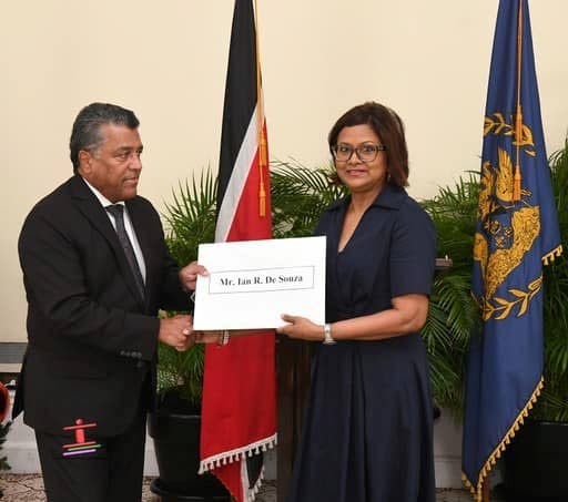 President Christine Kangaloo presents former banker Ian De Souza with his instrument of appointment as chairman of the Salaries Review Commission at President's House on December 7.  - Photo courtesy Office of the President