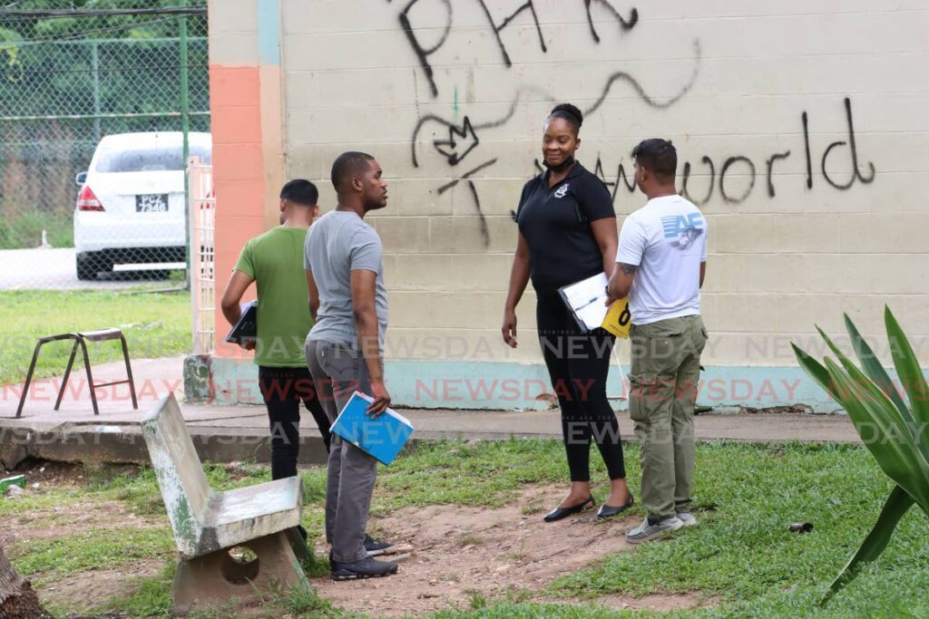 Crime Scene Investigators look for evidence after a man was killed and another injured at Paradise Heights, Morvant on Sunday. - Photo by Angelo Marcelle