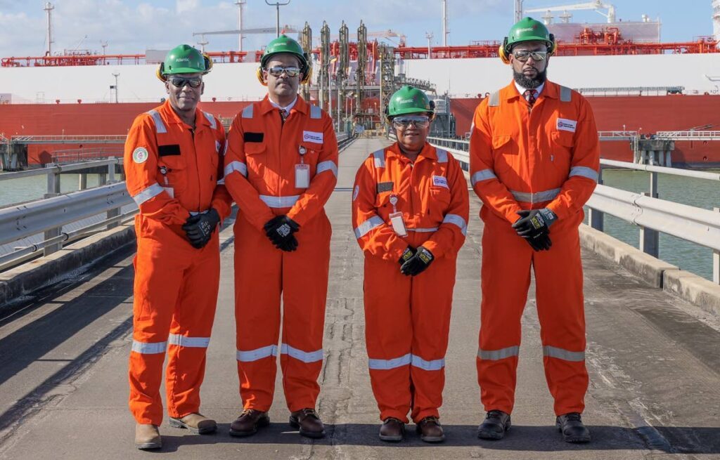 NGC executives, from left, VP operations Ian Walcott, acting president Edmund Subryan, VP commercial Verlier Quan-Vie and chairman Dr Joseph Ishmael Khan stand in front of the first cargo of liquefied natural gas (LNG) from Atlantic’s Trains Two and Three at its facility in Point Fortin recently. - Photo courtesy NGC