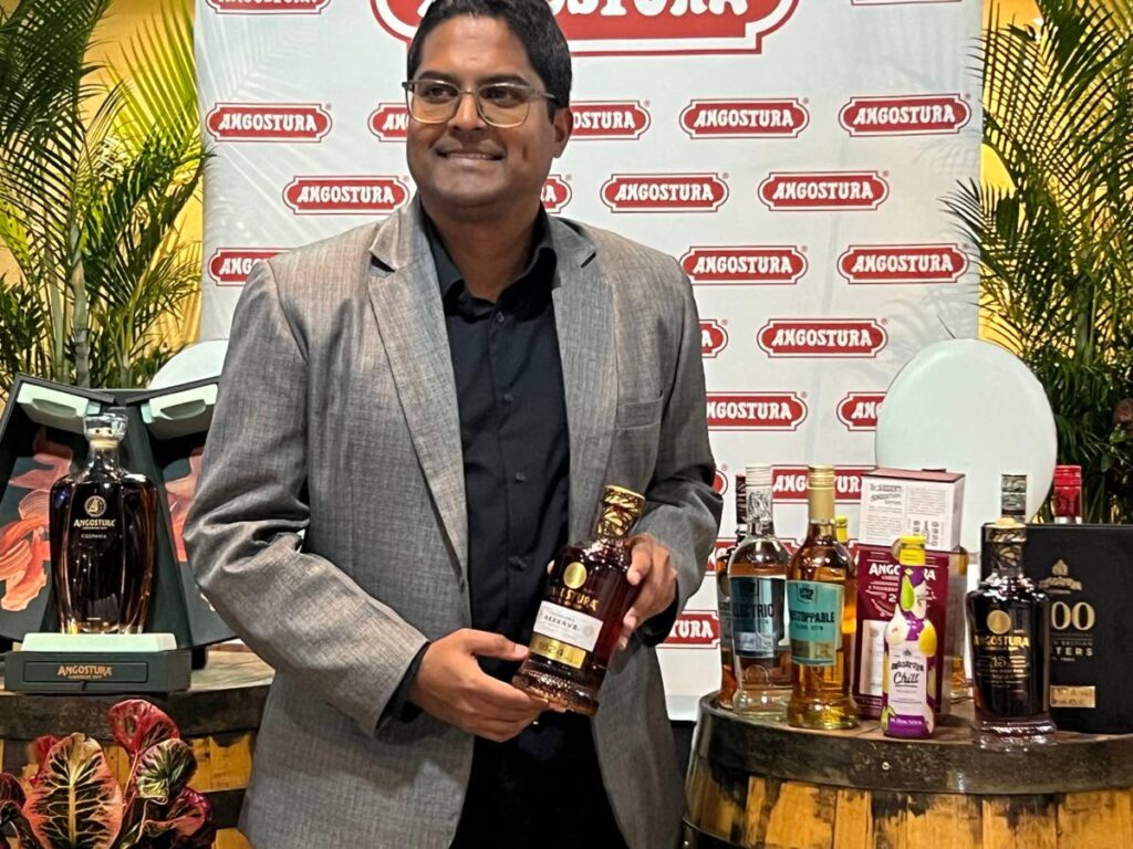 Mohammed holds the 1824 bottle of rum at the earning call meeting at the House of Angostura, Laventille on December 9 - Enrique Rupert