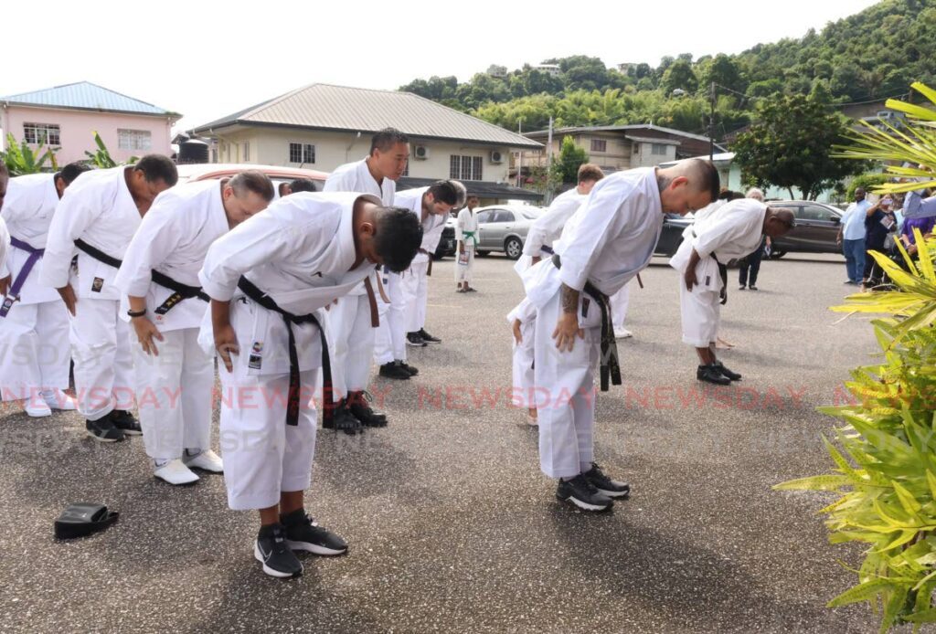 Adam Chin Leung Kam, second right, son of Sensei Brian Chin Leung Kam, leads fellow karateka through a tribute to his father at the end of the funeral at the Church of the Nativity, Crystal Stream, Diego Martin on December 12. - Photo by Faith Ayoung