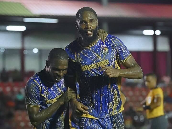 Defence Force central defender Jelani Peters (R) is congratulated by Shaquille Bertrand after scoring the winning goal in their team's TT Premier Football League clash with San Juan Jabloteh at the Phase 2 La Horquetta Recreation Ground on December 13. Photo courtesy TTPFL.  - 