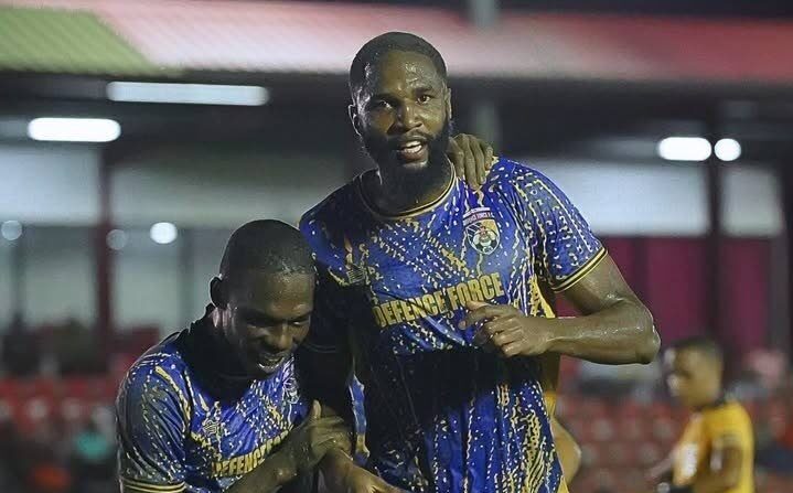 Defence Force central defender Jelani Peters, right, is congratulated by Shaquille Bertrand after scoring the winning goal in their team's TT Premier Football League clash with San Juan Jabloteh at the Phase 2 La Horquetta Recreation Ground on December 13. - Photo courtesy TTPFL