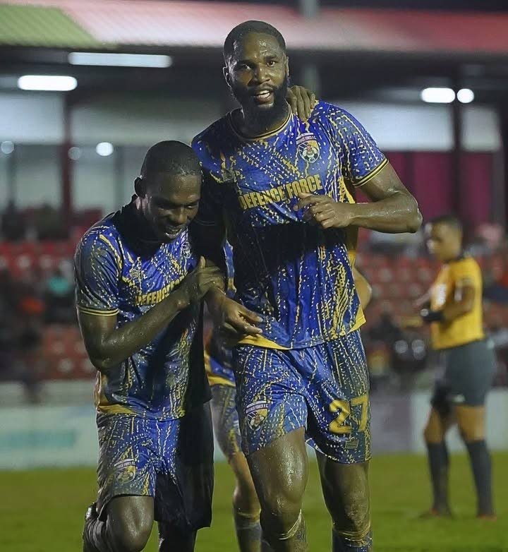 Defence Force central defender Jelani Peters (R) is congratulated by Shaquille Bertrand after scoring the winning goal in their team's TT Premier Football League clash with San Juan Jabloteh at the Phase 2 La Horquetta Recreation Ground on December 13. Photo courtesy TTPFL.  - 