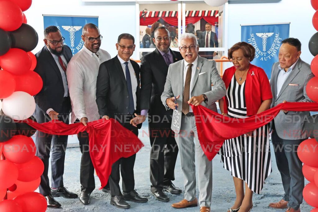 From left, NGC chairman Joseph Ishmael Khan, Heritage Petroleum Co Ltd chairman  Michael Quamina, president of Phoenix Gas Processors Ltd Dominic Rampersad, SWRHA CEO Dr Brian Armour, Minister of Health Terrence Deyalsingh, SWRHA chairman Valerie Alleyne-Rawlins and Pointe-a-Pierre MP David Lee, cut the ribbon of open the Cancer Centre of Trinidad and Tobago, South, formerly the Augustus Long Hospital in Pointe-a-Pierre on December 14. - Photo by Lincoln Holder 