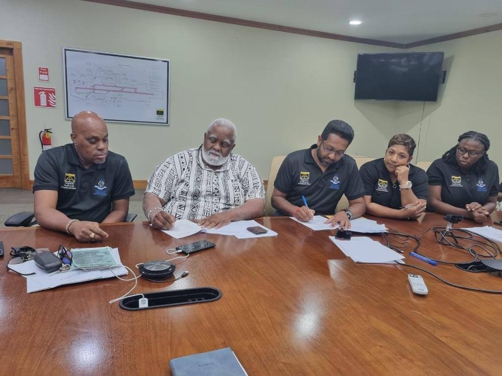 President of the Estate Police Association Deryck Richardson, second from left, signs an agreement at the airport's administrative centre in Piarco on December 11. - Photo courtesy Airports Authority of TT