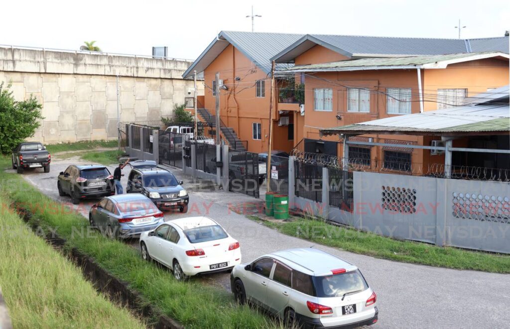 Cars line up outside the building where Zahir Khan, 71, was abducted the morning of December 14 on Jamurath Street, Bamboo Settlement #1.  - Faith Ayoung