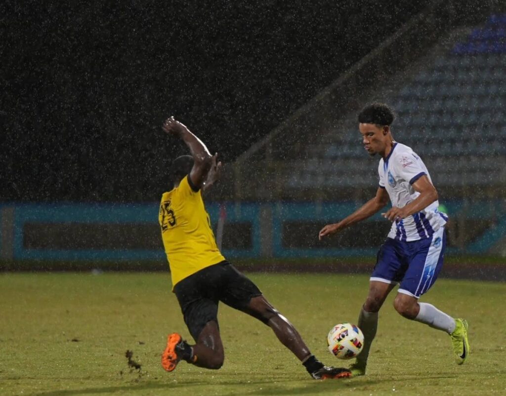 Eagles FC winger Gary Griffith III (R) skips past the recount of a Central FC participant within the center of their TT Premier Football League match on the Ato Boldon Stadium in Couva on December 14. Photo courtesy TTPFL.  - 