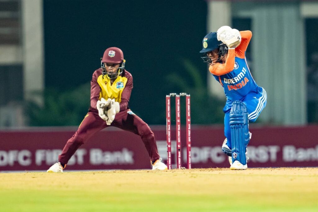 West Indies women's wicket-keeper Shemaine Campbelle looks on as India's Jemimah Rodrigues plays a shot through the off-side during the teams' first T20 at the DY Patil Stadium in Navi Mumbai on December 15. Photo courtesy Indian Cricket Team's Facebook page.  - 