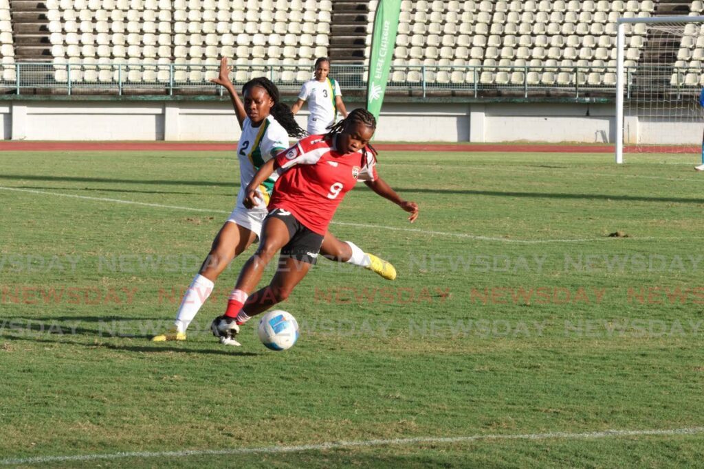 Trinidad and Tobago’s Nikita Gosine (R) controls the ball against Dominica’s Kenya John during the girls’ U20 Jewels of the Caribbean tournament match, on December 15, 2024, at Larry Gomes Stadium, Malabar. - Faith Ayoung