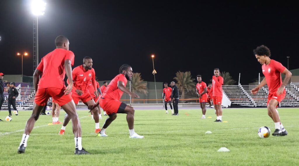 Michel Poon-Angeron, right, has the attention of his teammates during a training session in Saudi Arabia. PHOTO COURTESY TTFA FACEBOOK  - PHOTO COURTESY TTFA FACEBOOK