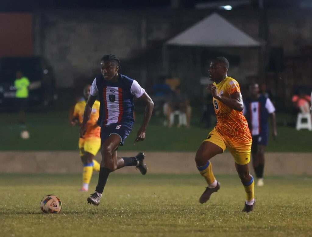 Caledonia AIA's Solomn Austin (L) goes past AC Port of Spain defender Kerron St Cyr during their TT Premier Football League match, on December 15, 2024, at the Police Barracks, St James. - via TTPFL