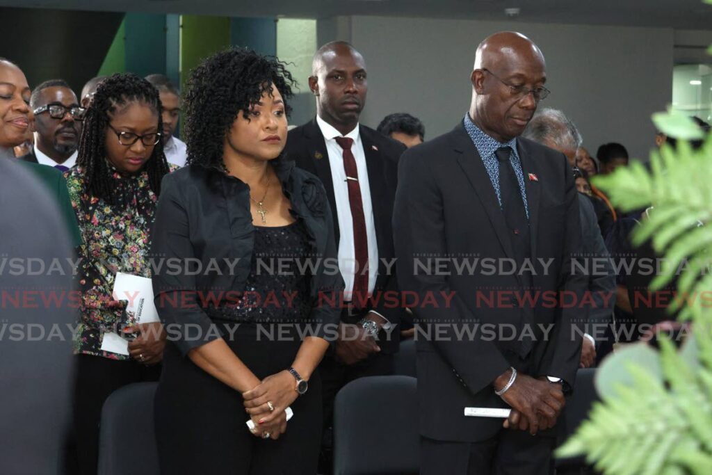 The Prime Minister and Education Minister Dr Nyan Gadsby-Dolly at a memorial service for Minister in the Ministry of Education Lisa Morris-Julian at the ministry, St Vincent Street, Port of Spain on December 17. Morris-Julian and two of her children, Xianne and Jesiah, were killed in a fire at their Farfan Street, Arima home on December 16.  - Faith Ayoung