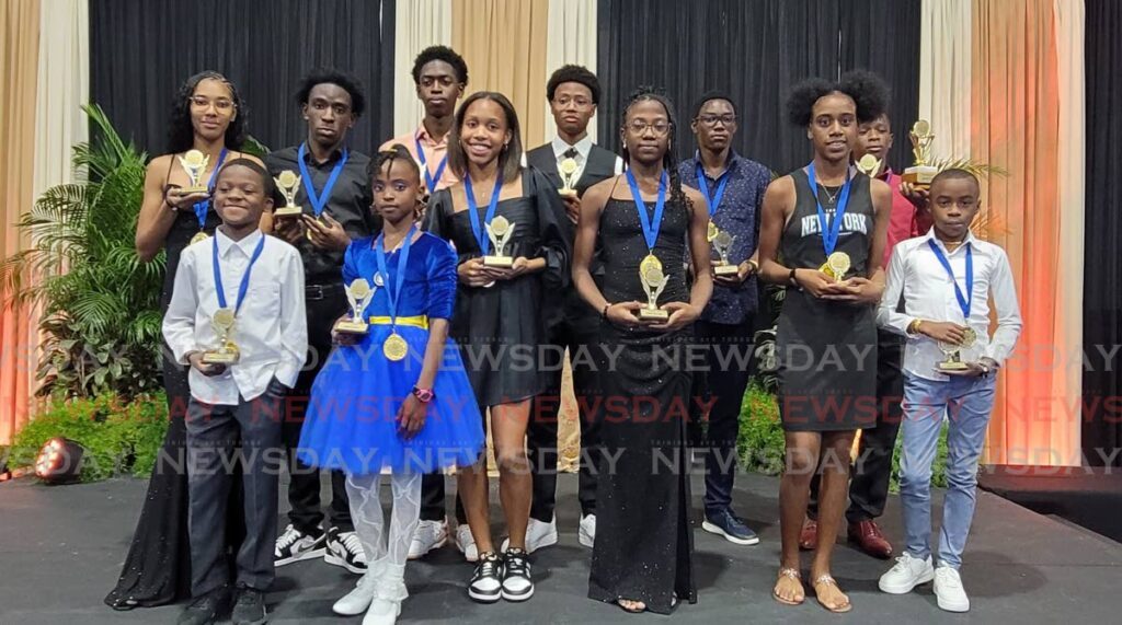 Memphis Pioneers athletes proudly display their trophies and medals at the track and field club's 2024 award ceremony, held at the International School of Port of Spain on December 14.  - Photo by Jelani Beckles