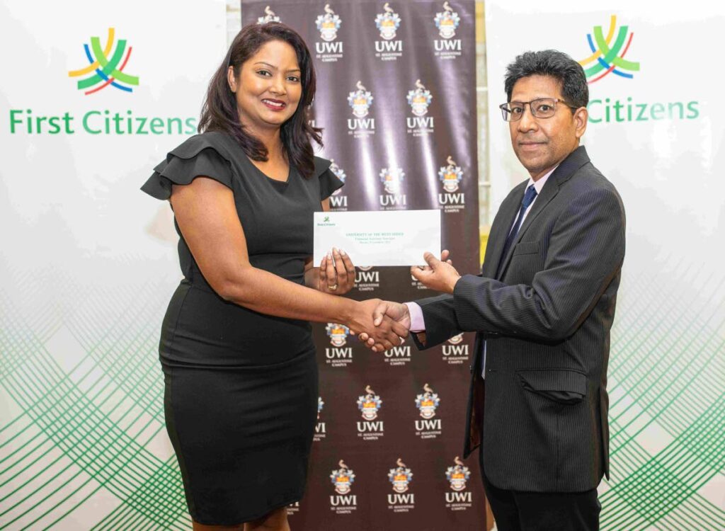 Tamara Ramlogan, assistant branch manager of First Citizens Tunapuna, left, presents a bursary to Prof Derek Chadee, campus deputy principal UWI St Augustine.
Photo courtesy First Citizens - 