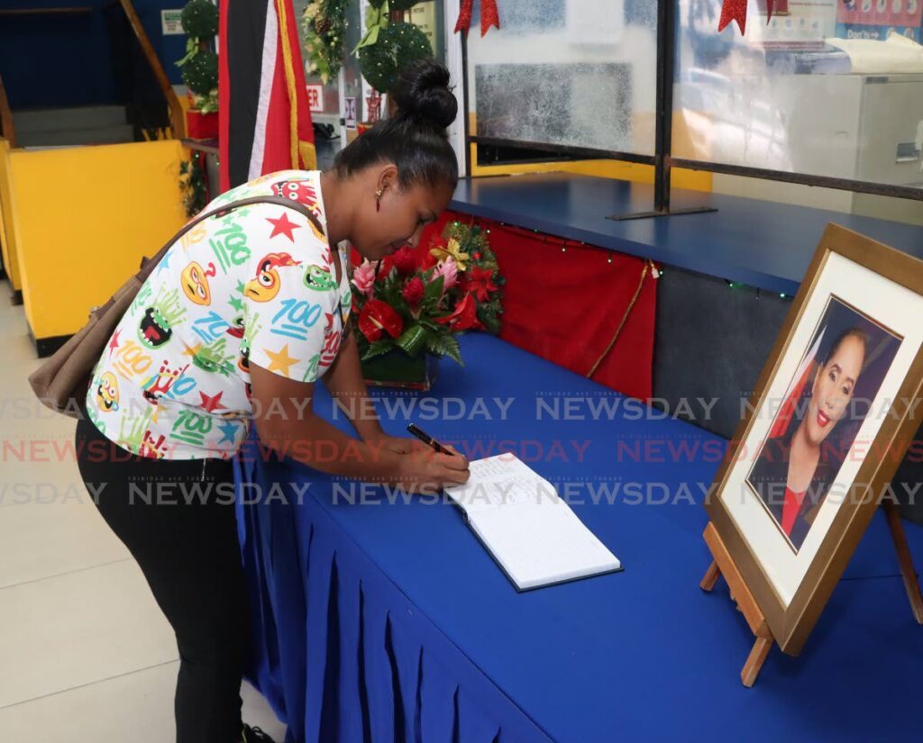 Kesha Lakhan signs the condolence book for deceased MP Lisa Morris-Julian at the Arima Borough Corporation, Xtra Plaza on December 19. - Photo by Angelo Marcelle