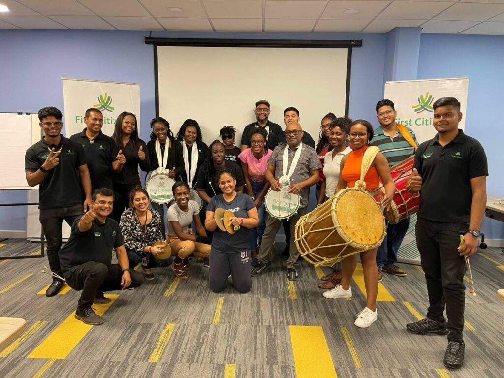 First Citizens employees with members of the First Citizens Dragon Boys Tassa Band at the tassa workshop. - 