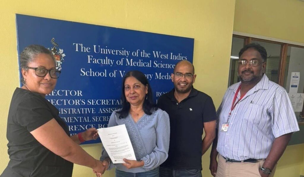 Dr Karla Georges, left, director of UWI-SVM presents the MoU to Nisa Surujbally, CPA executive director while lecturers Dr Shayne Ramsubeik and Dr Anil Persad, right, look on. - Photo courtesy the UWI 