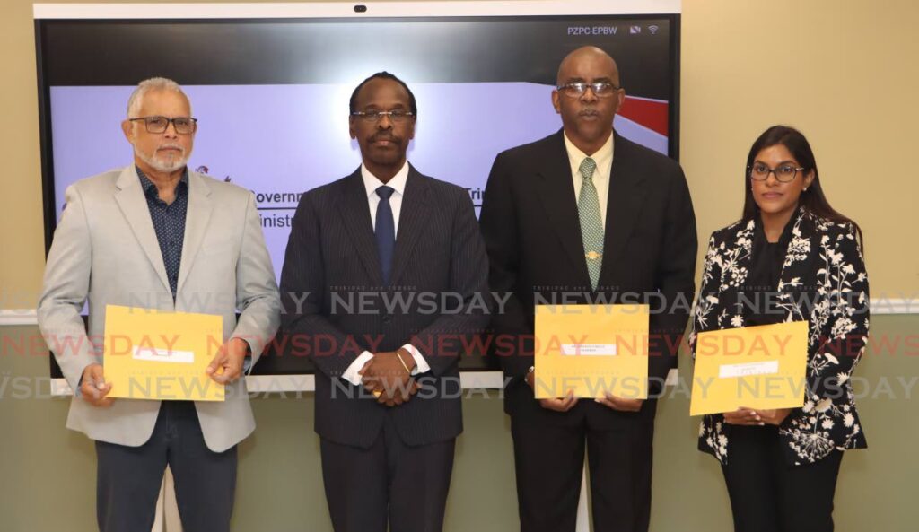 Minister of National Security Fitzgerald Hinds, second from left, is flanked by, from left, Curt Cadet, chairman Roosevelt Bruce and Ashti Mahabir, at Ministry of National Security, Port of Spain on December 20. The group is tasked with investigating the fire service's response to the fire that caused the death of MP Lisa Morris-Julian and two of her children on December 16. - Angelo Marcelle