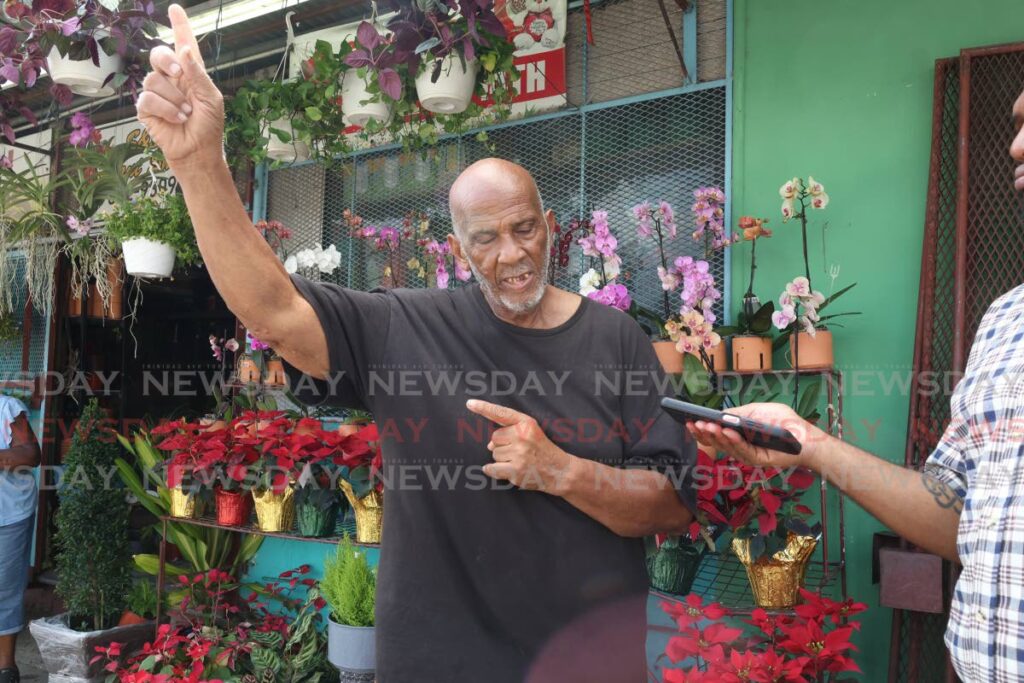 William Samuel, father of Zaheer Samuel,15, who was kidnapped on December 18, speaks with reporters at his plant shop on the Eastern Main Road in St Augustine on December 20. - Faith Ayoung