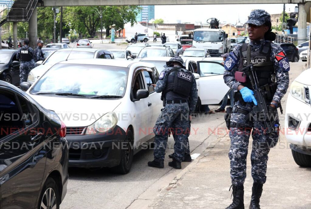 Police, licensing officers and traffic wardens conduct a road block on St Joseph Road, Port of Spain, on December 20. - Photos by Faith Ayoung