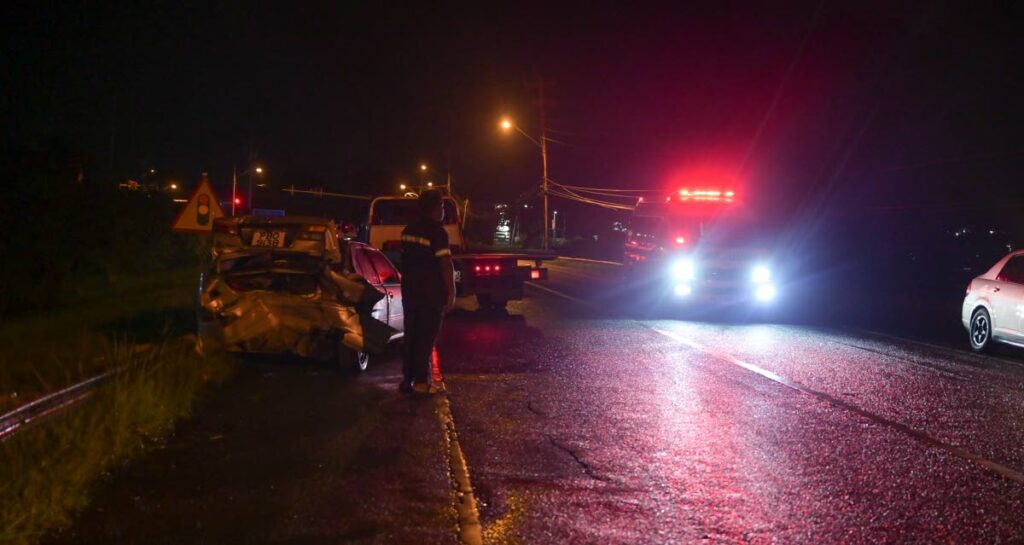 Emergency workers at the scene of a fatal accident along the Claude Noel Highway in Tobago which claimed the life of Stephon Grant on December 20. - Photo by Visual Styles