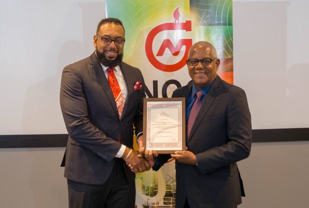 National Gas Company (NGC) chairman Dr Joseph Ishmael Khan, left, receives the certificate of compliance from Integrity Commission chairman Haydn Gittens in Port of Spain on December 19.  - Photo courtesy NGC