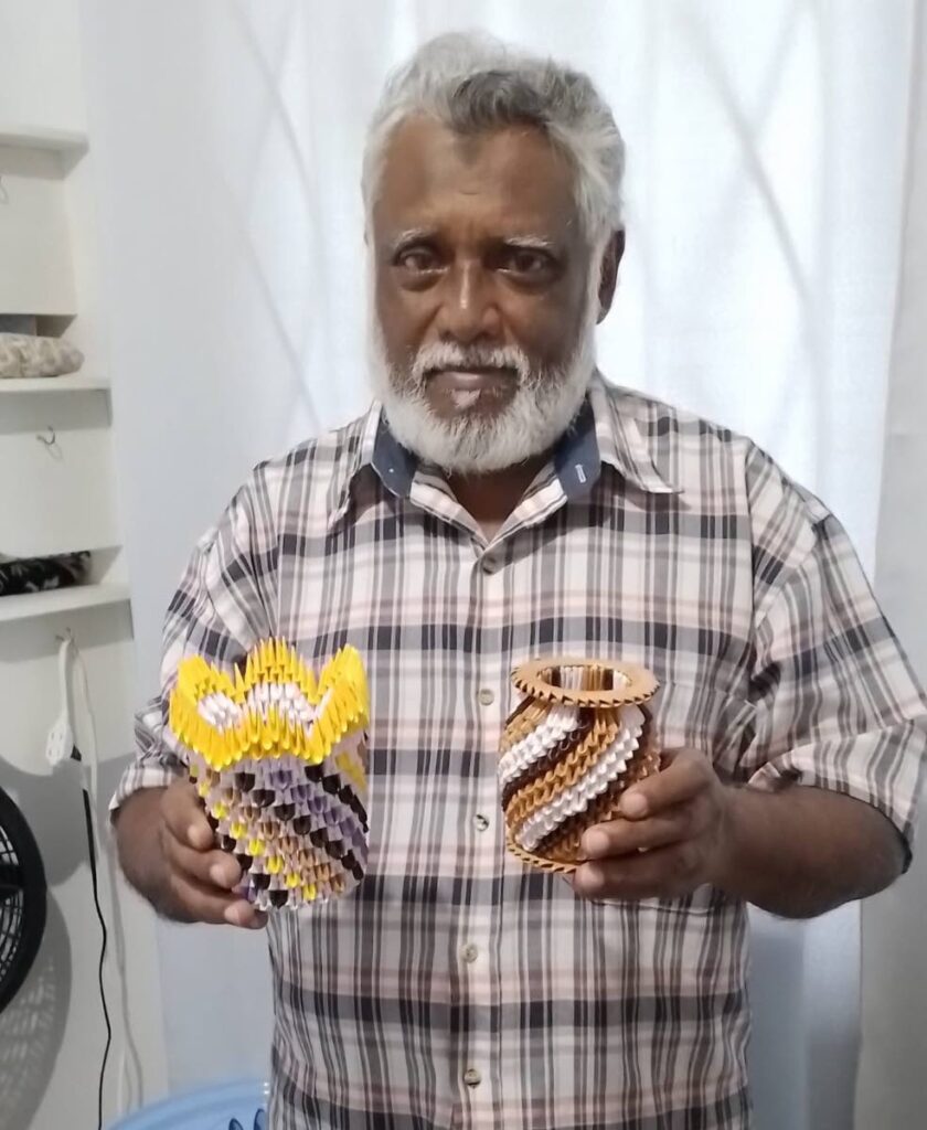 Kashma Khan shows off his origami pieces. Khan is manager and curator of the ASJA Archives and Museum,  Education Complex, Charlieville. - 