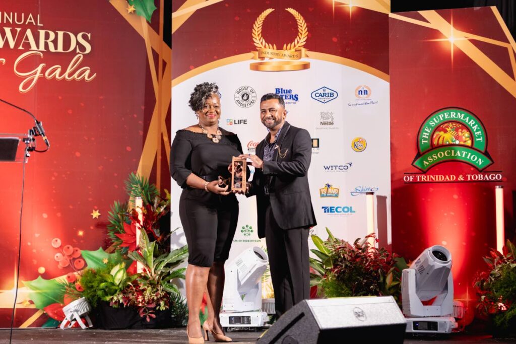 Kiss Baking Company Ltd representative, left, receives the award of Product Innovation of the Year from Kevin Kissoon, SATT board member. 
Photo courtesy SATT.  - 