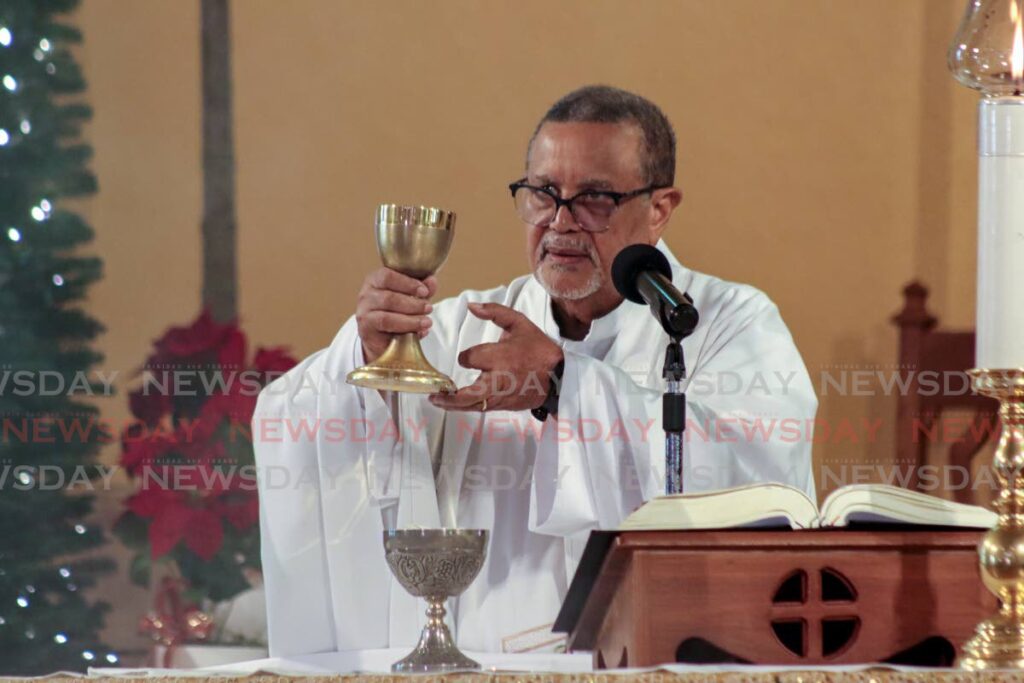 PRAY FOR HEALING: Fr Gerard Bernier officiated the Christmas Mass on December 25 at Our Lady of Perpetual Help, Harris Promenade, San Fernando.  - Photo by Grevic Alvarado
