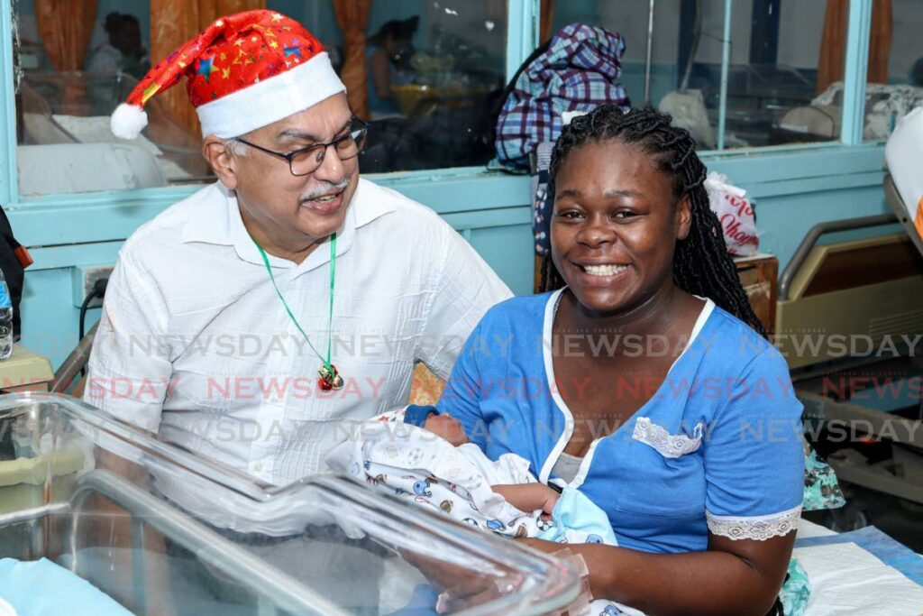 Baby Elisha Huggins and her mom, Kerdisha Duntin, receive a visit from Health Minister Terrence Deyalsingh at the San Fernando General Hospital on Boxing Day. Baby Elisha was born on Christmas Day.
 - Photo by Grevic Alvarado