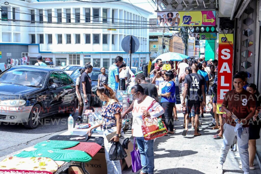 A handful of shoppers visited High Street, San Fernando, for Boxing Day bargains.
 - Photo by Grevic Alvarado