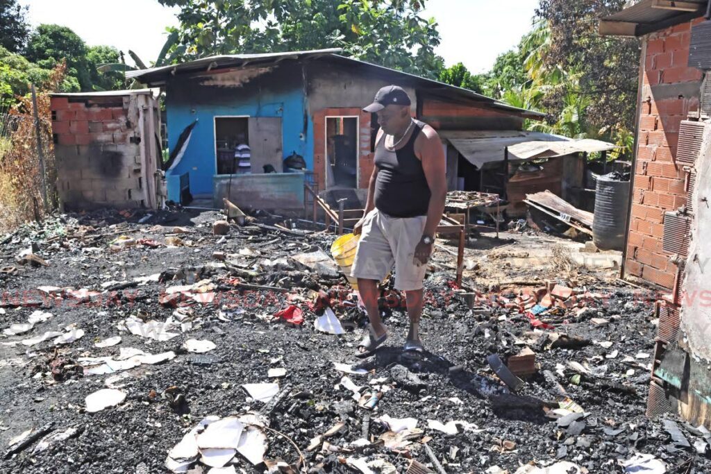 Gibert Corbin stands on the spot where his home once existed, after he lost his home to fire on Christmas Day along Polo Grounds, Preysal in Couva. Several other homes were affected. - Photo by Lincoln Holder 