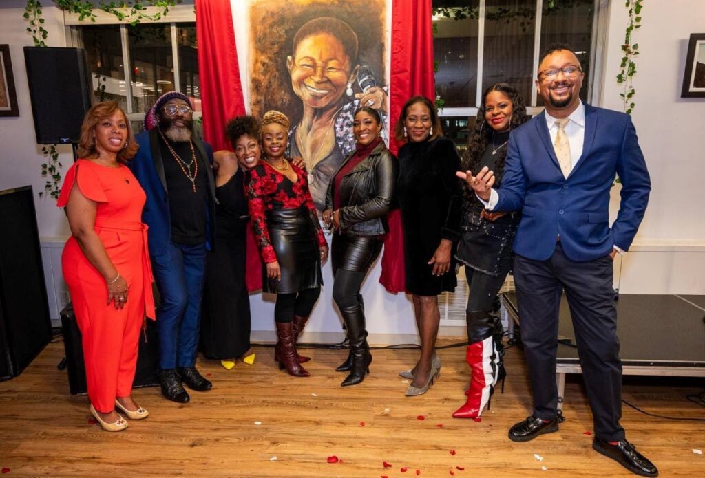 Alicia Aberdeen, third from left, with friends in front of her First Monarch painting. - Photo courtesy Colin Williams Photography 