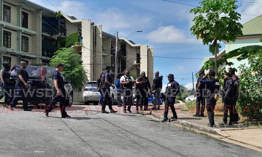 CRIME SCENE: A contingent of police at Paradise Heights in Morvant on December 30 after a man was gunned down.  -