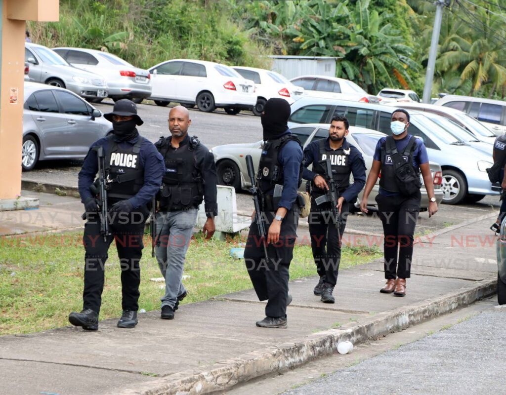 Police at Paradise Heights in Morvant after a man was gunned down on December 30.   - Photo by Ayanna Kinsale