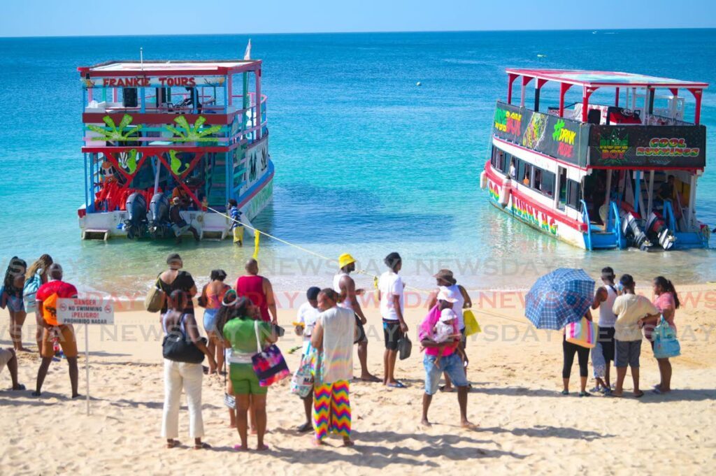 People wait to board glass-bottom boats at Store Bay on Christmas Day, ahead of a tour to the Buccoo Reef.
 - Photo courtesy Visual Styles