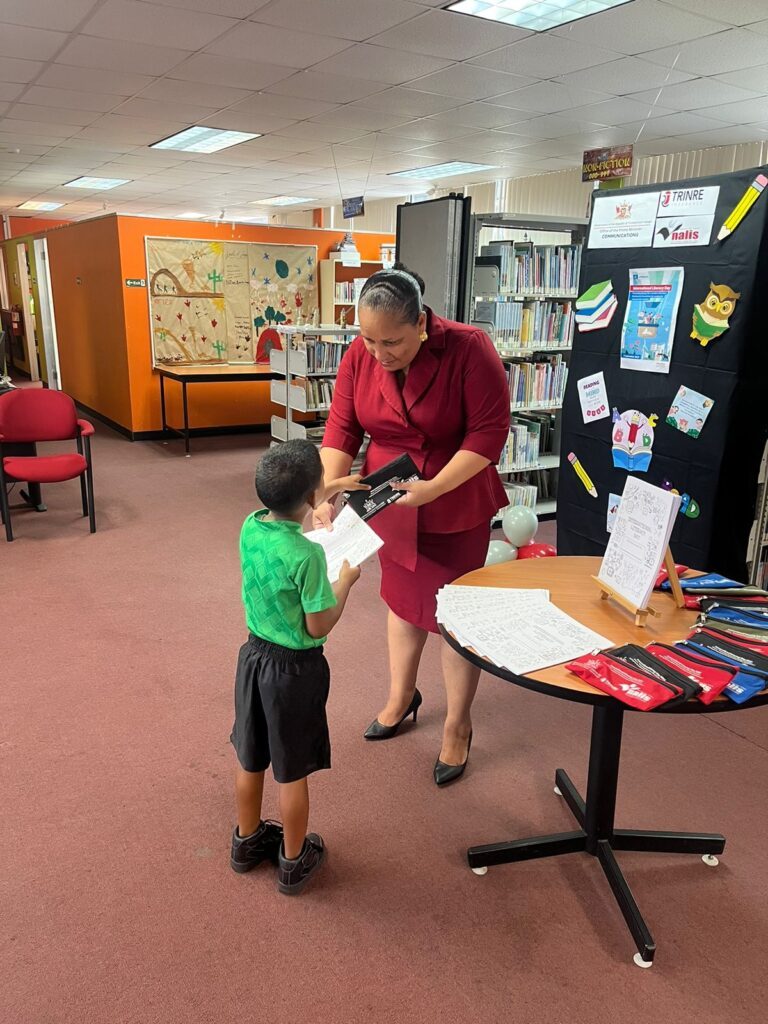 Lisa Morris-Julian, MP for D’Abadie/O’Meara and Minister in the Ministry of Education, gives a little boy a gift for attending the Arima Public Library International Literacy Day event in September 2023. Morris-Julian and two of her children, Xianne and Jesiah, died in a fire at their Farfan Street, Arima home on December 16. -