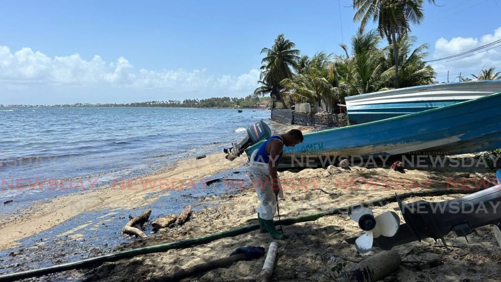 An oil-stained boat on the shore of Petit Trou beach, Lambeau, Tobago.  - 