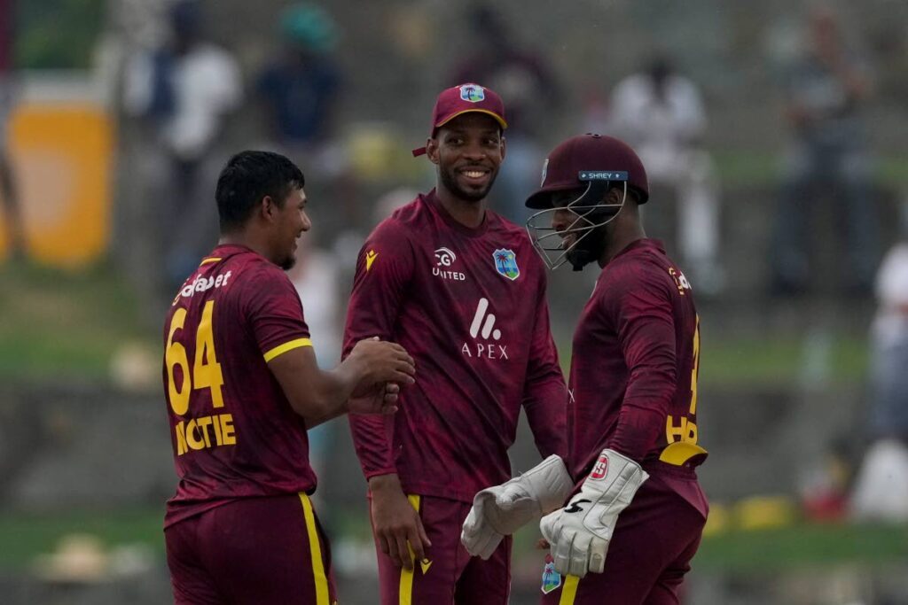 West Indies' Gudakesh Motie, left, celebrates with teammates Roston Chase, center, and captain Shai Hope taking the catch to dismiss England's captain Liam Livingstone during the first ODI at Sir Vivian Richards Ground in North Sound, Antigua and Barbuda, on October 31, 2024. - AP PHOTO