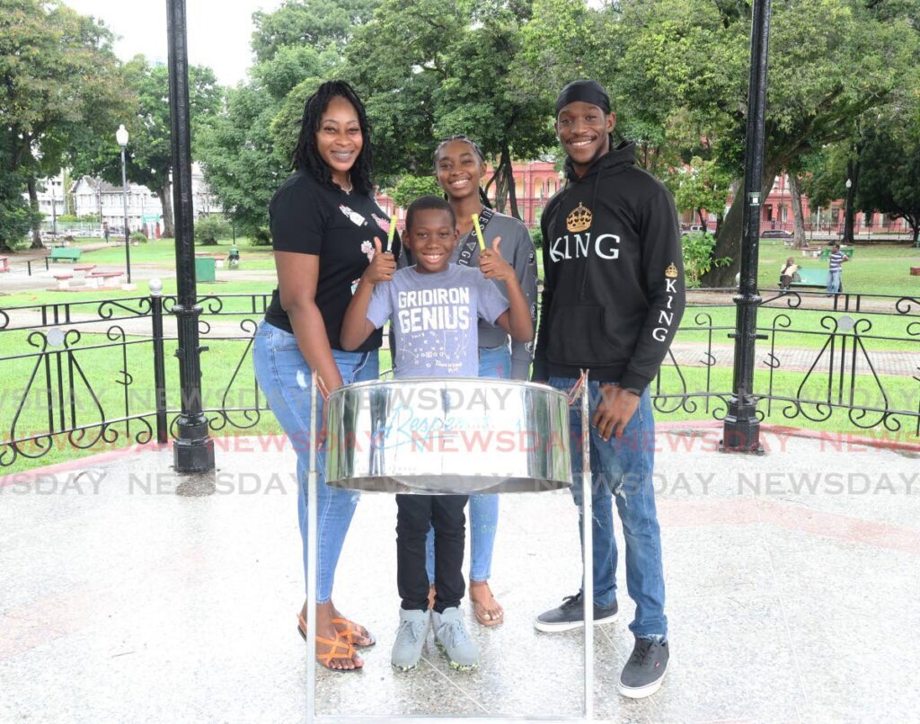 Torion Titus, who plays for the single pan band Stereonettes,  with pan-playing family: mother Dianna Pierre, 16-year-old sister Esther Arvelay and brother Jaheim Pierre at Woodford Square, Port of Spain, on January 2. - Faith Ayoung