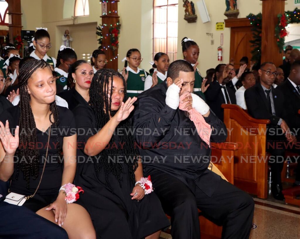 From right, Daniel Julian, the widower of D'Abadie/O'Meara MP Lisa Morris-Julian, and other relatives at the funeral of Morris-Julian and two of their children, Xianne  and Jesiah, at the Santa Rosa RC Church in Arima, on January 2. - Photo by Ayanna Kinsale