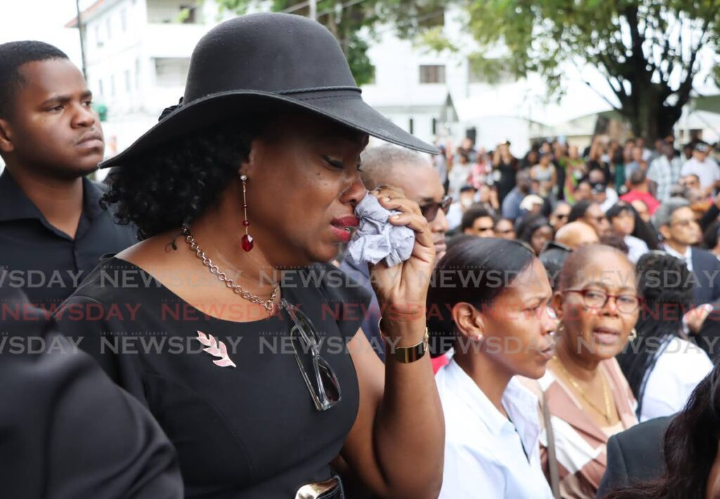 A woman weeps during the funeral of D'Abadie/O'Meara MP Lisa Morris-Julian and two of her children at the Santa Rosa RC Church in Arima on January 2. - Photo by Ayanna Kinsale