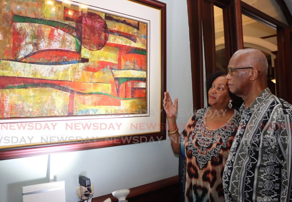 Karen Bart-Alexander, and Erdly Howard-Webbe look at LeRoy Clarke's Pedestal of Stone during the National Museum and Art Gallery of TT's opening of Recharting the Ruin exhibition Castle Killarney, Port of Spain on January 3. - Photos by Ayanna Kinsale