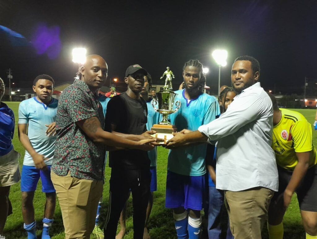 (FILE) Then-Eastern Football Association (EFA) general secretary Gregory McBurnie (right) and former Fifa assistant referee Kevin Lewis (left) present the 2024 EFA trophy to Malabar Youngstars in October 2024. Photo courtesy EFA.  - 