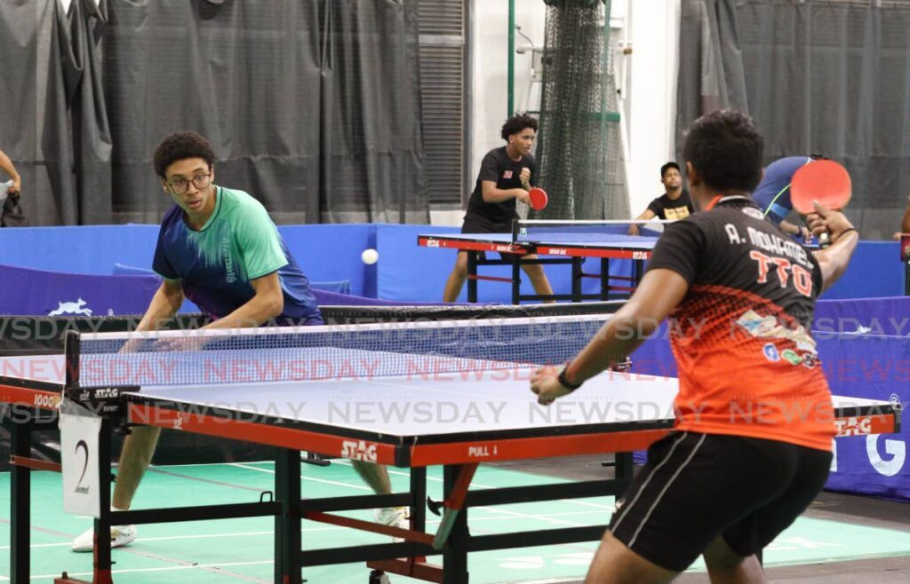 Gabriel John (L) plays against A Mohammed at the TT Table Tennis Association’s national trials at the National Racquet Centre, Tacarigua on January 4. - Photo by Faith Ayoung