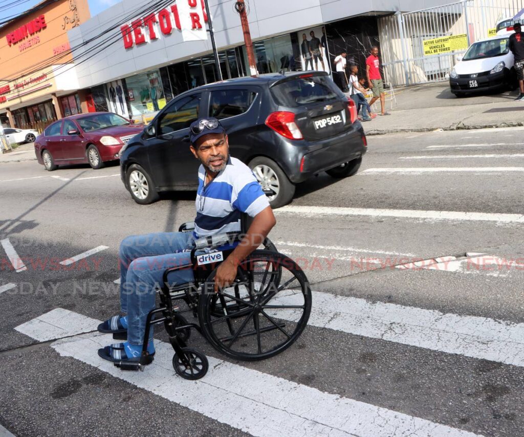 Angelo Marcelle uses the crosswalk by the Tunapuna Magistrate's Court which he found to be challenging. - Photo by Angelo Marcelle