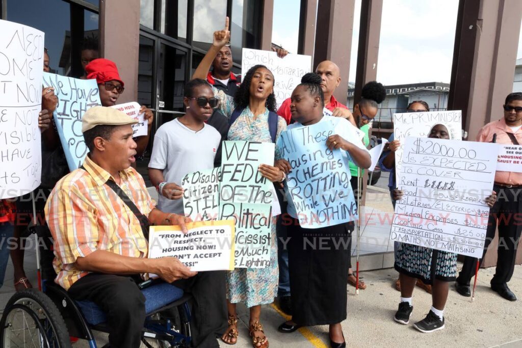 WE WILL BE HEARD: Members of the disabled community during their protest on January 8 outside the head office of the Housing Development Corporation on South Quay, Port of Spain. - Photo by Faith Ayoung